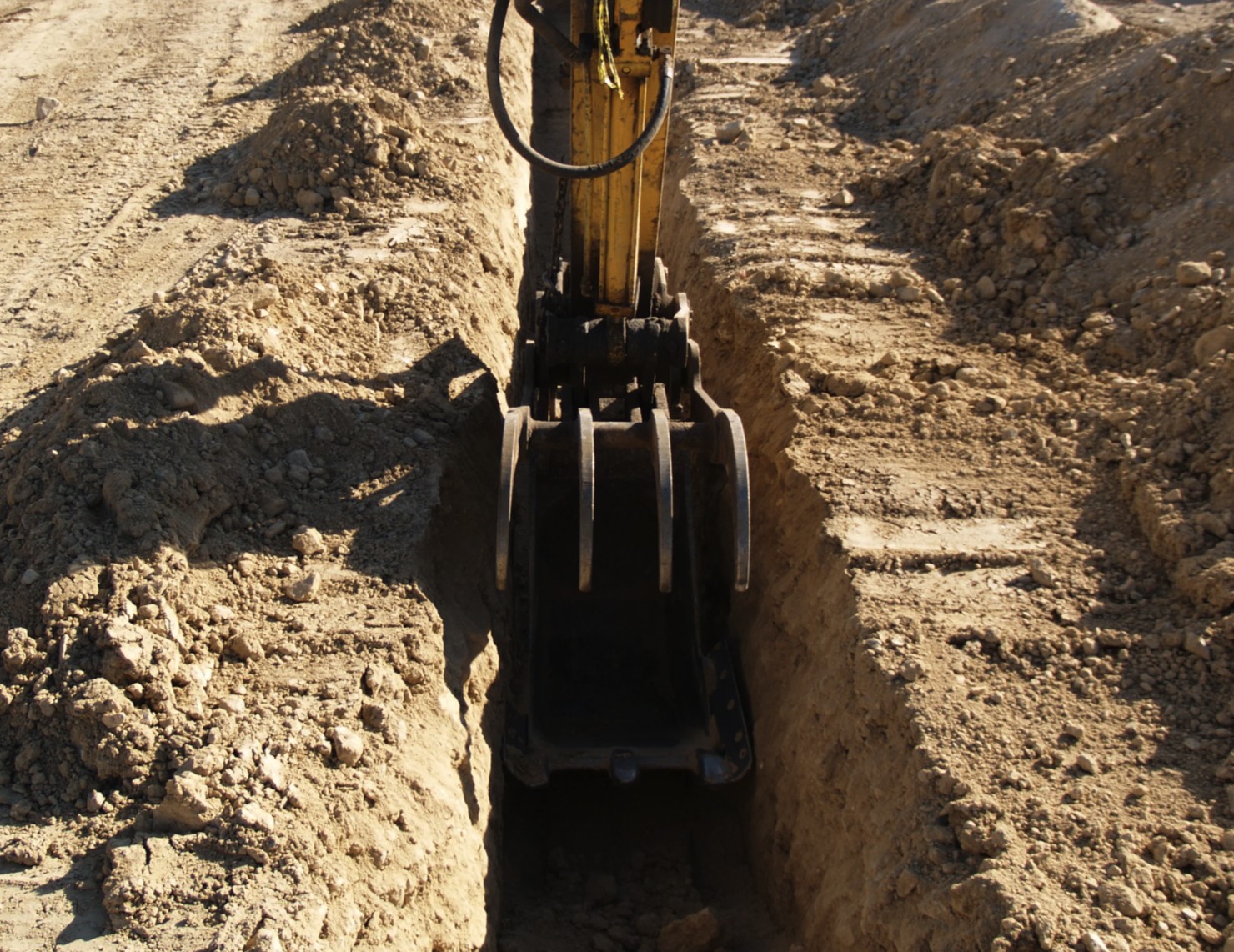 A machine digging a hole in the ground.